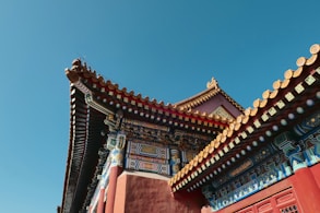 brown and white concrete building under blue sky during daytime