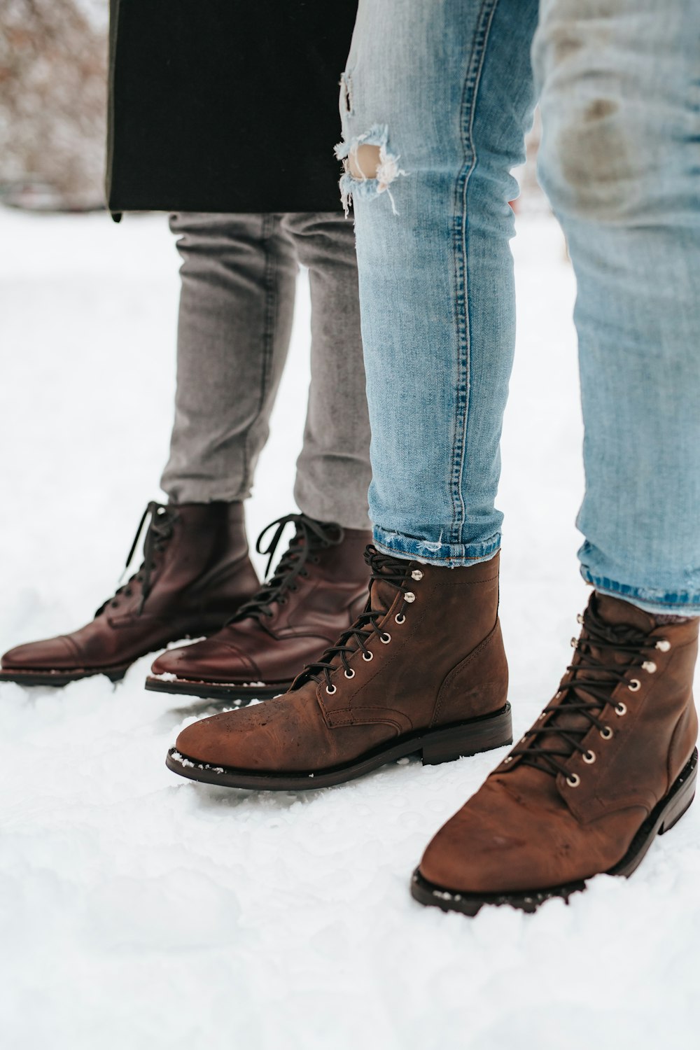 person in blue denim jeans and brown leather boots