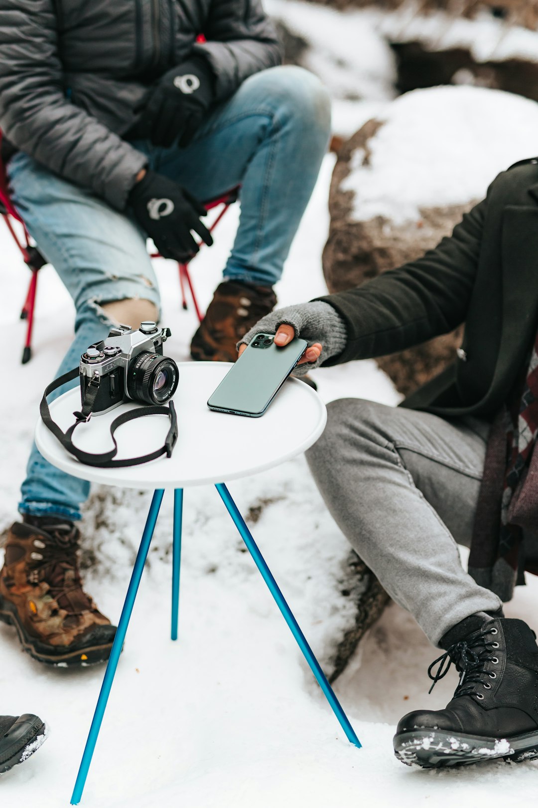 person in gray pants and black jacket holding black dslr camera