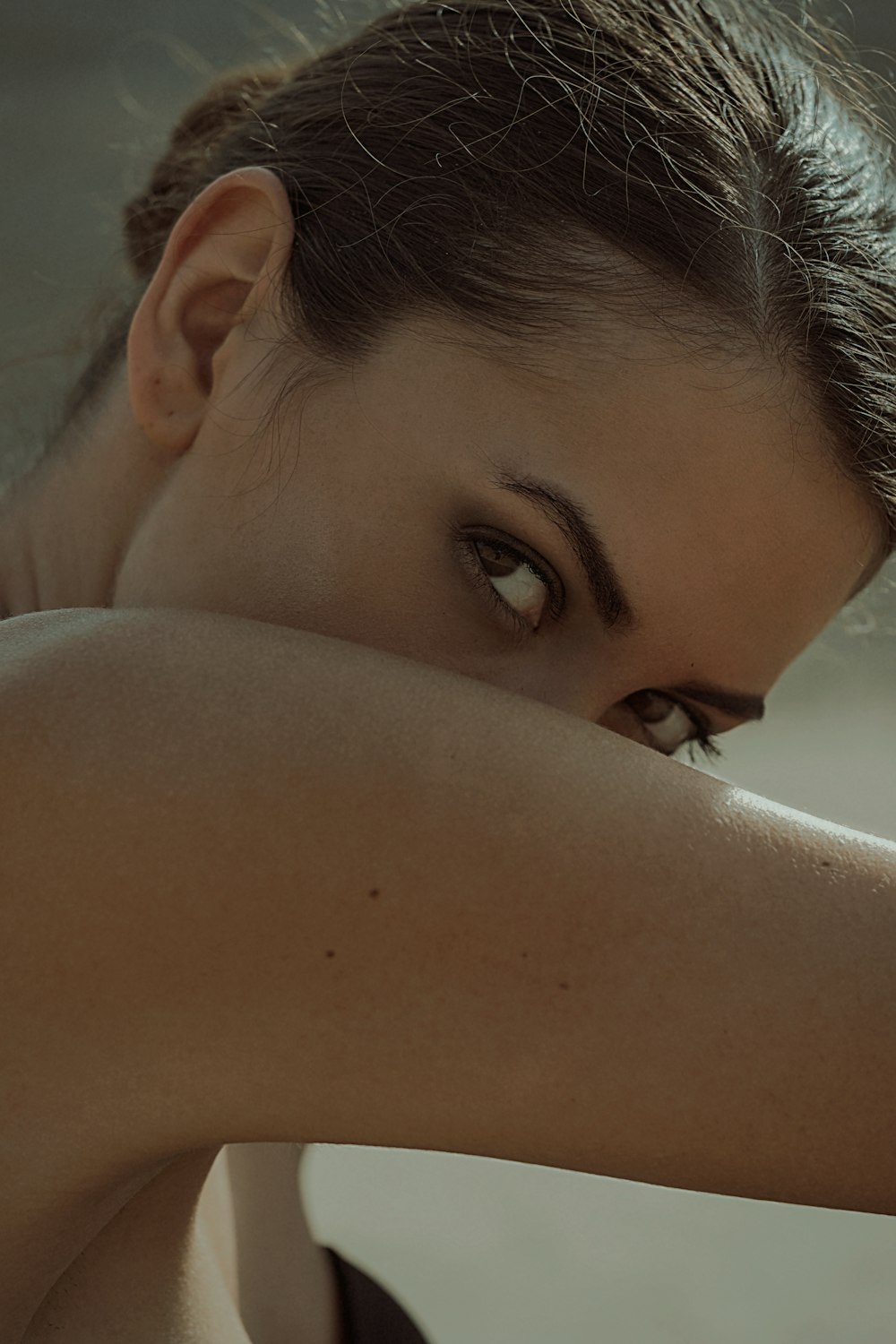 woman with black hair looking down