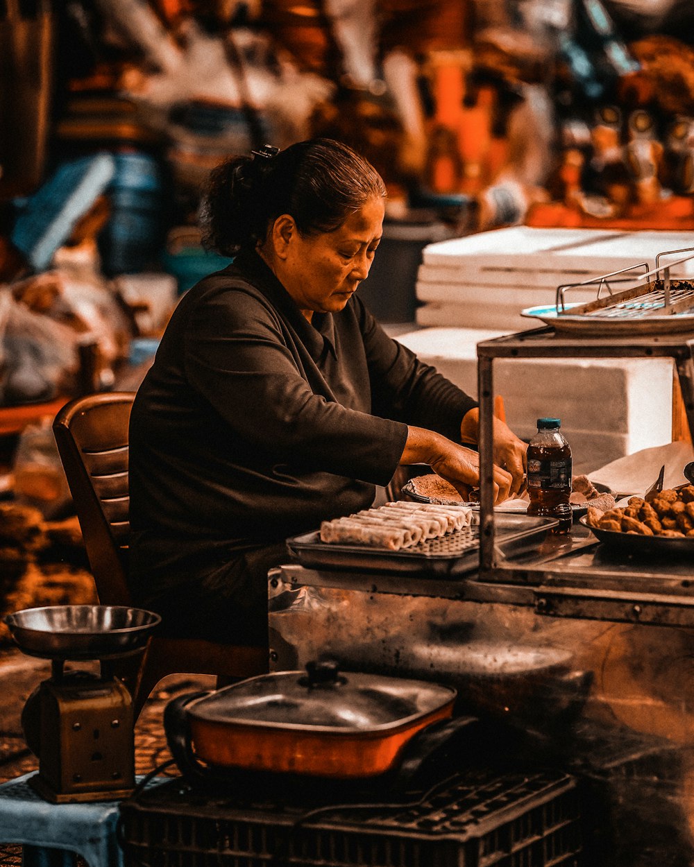 woman in black long sleeve shirt sitting by the table