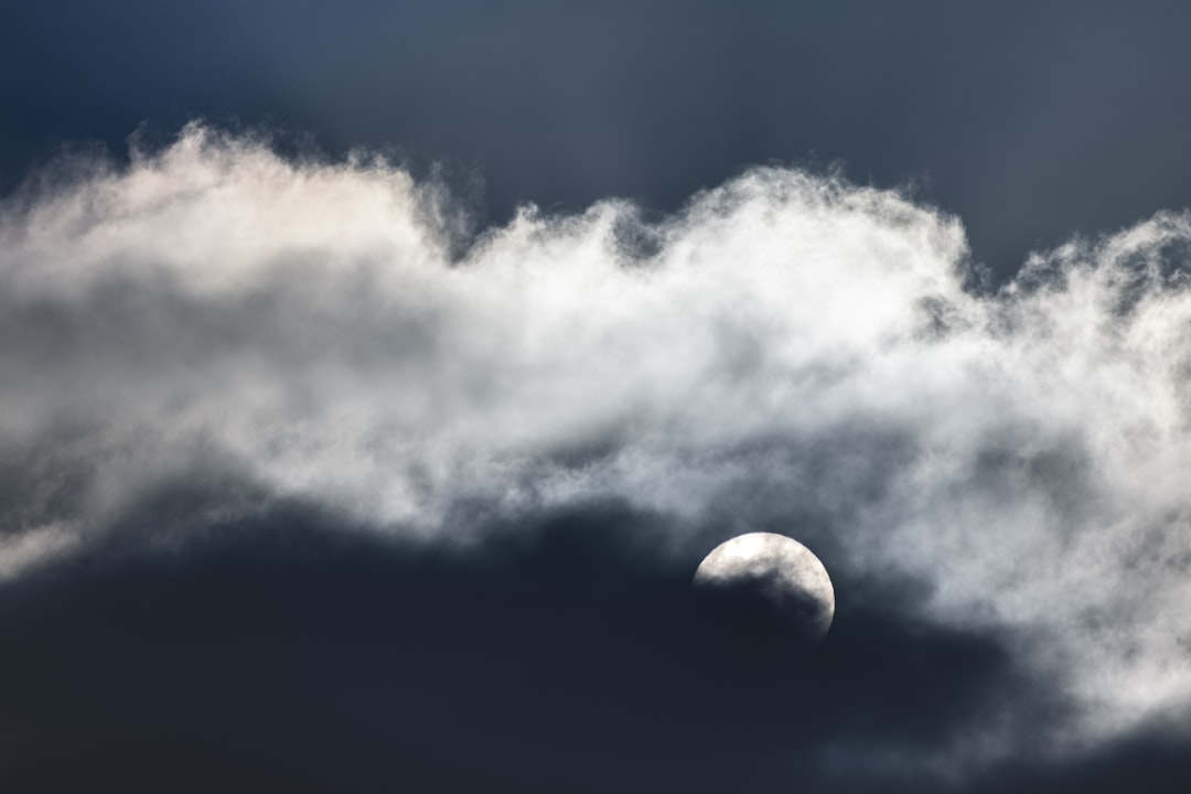 white clouds and blue sky, Sun setting behind clouds