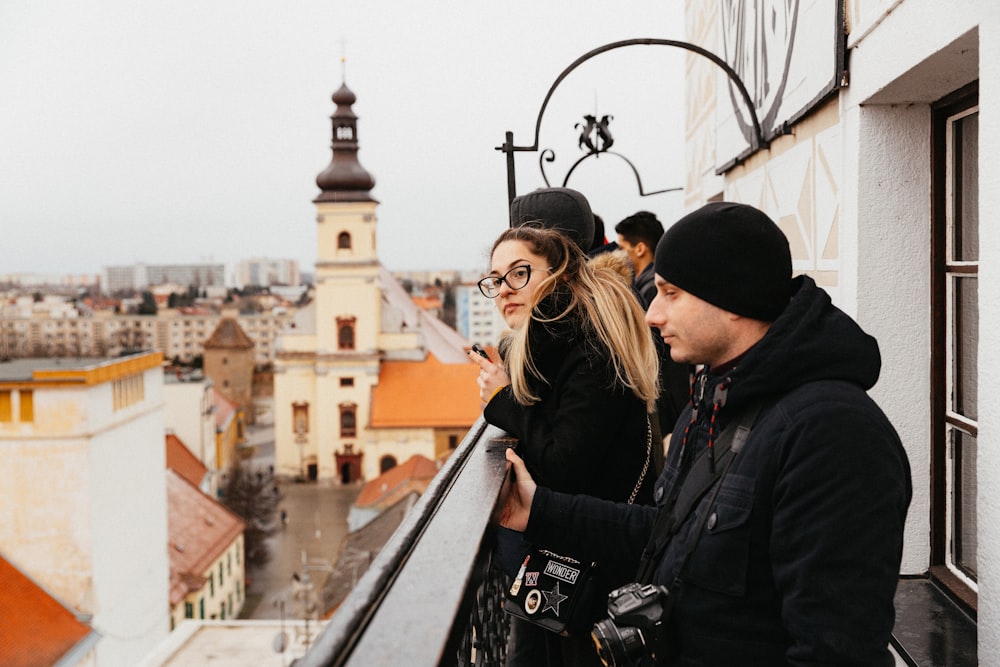 man and woman standing on top of building during daytime