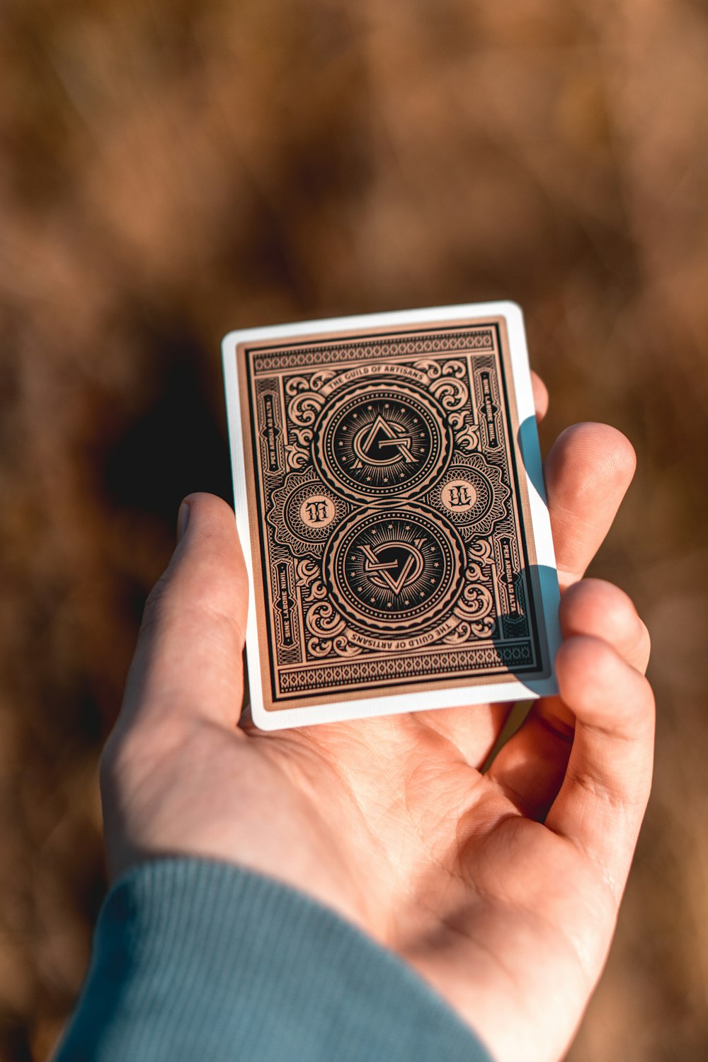 person holding black and white playing card