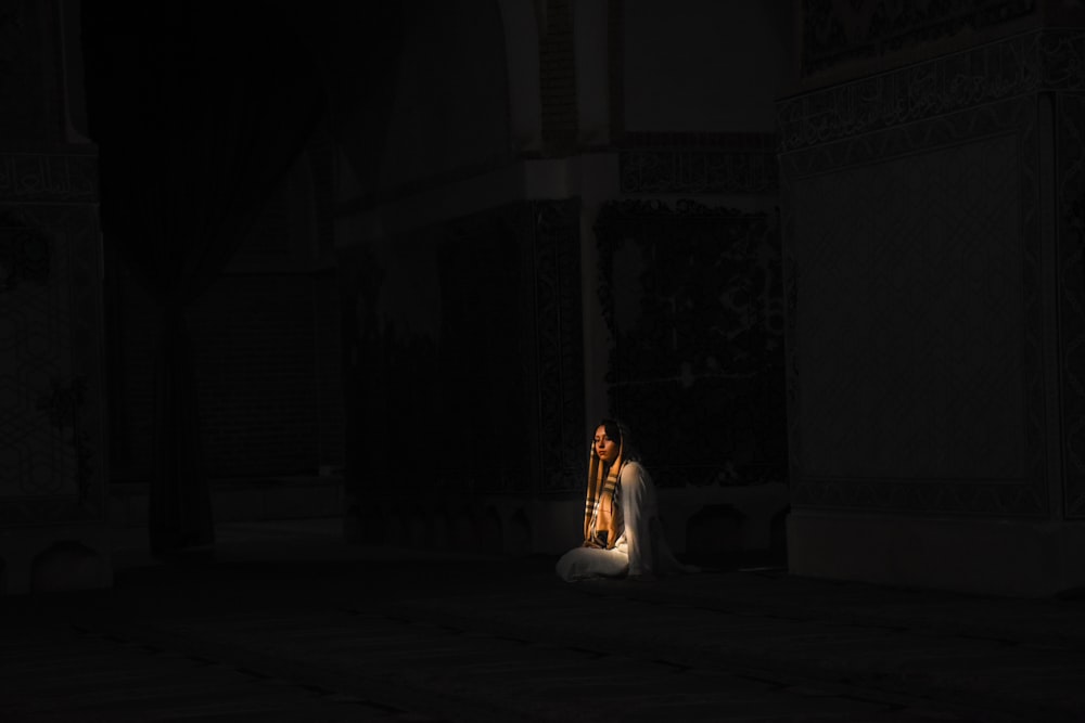 woman in white dress sitting on floor