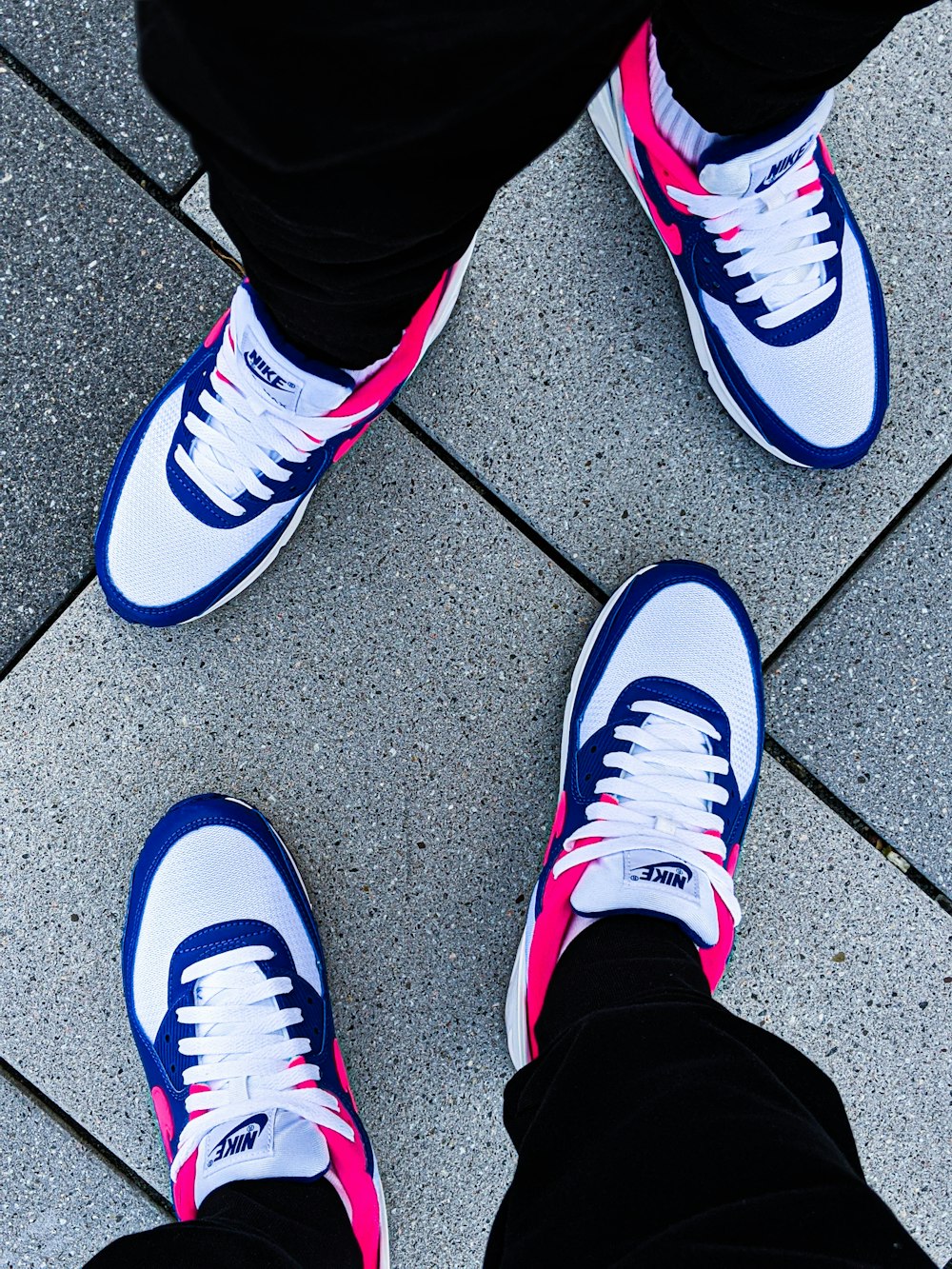 person wearing white and purple nike sneakers
