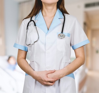 woman in white button up shirt and blue stethoscope