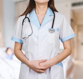 woman in white button up shirt and blue stethoscope