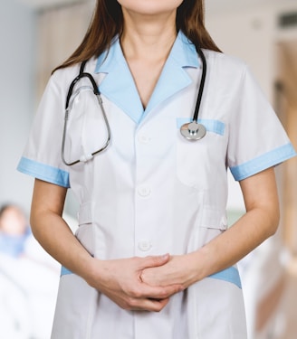 woman in white button up shirt and blue stethoscope