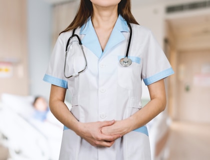 woman in white button up shirt and blue stethoscope