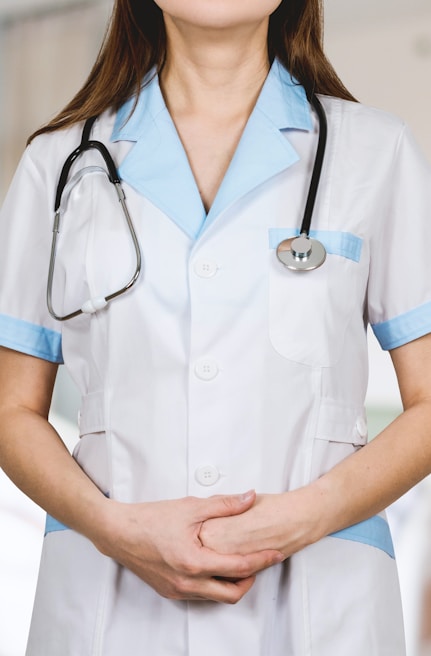 woman in white button up shirt and blue stethoscope