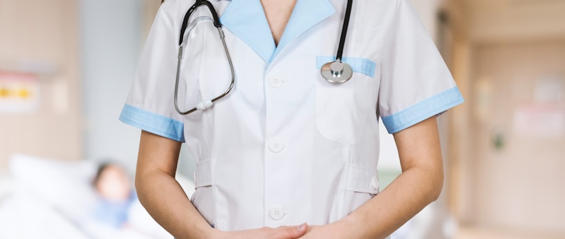 woman in white button up shirt and blue stethoscope