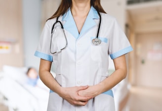 woman in white button up shirt and blue stethoscope