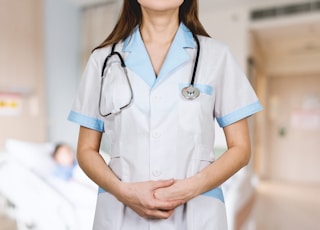 woman in white button up shirt and blue stethoscope