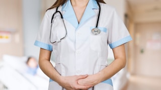 woman in white button up shirt and blue stethoscope