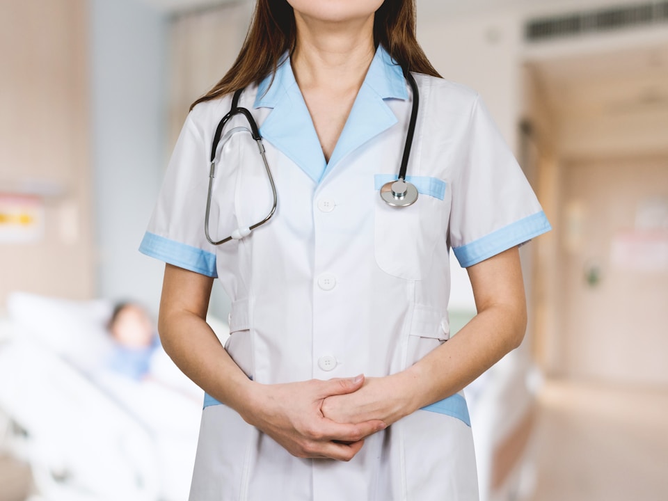 woman in white button up shirt and blue stethoscope