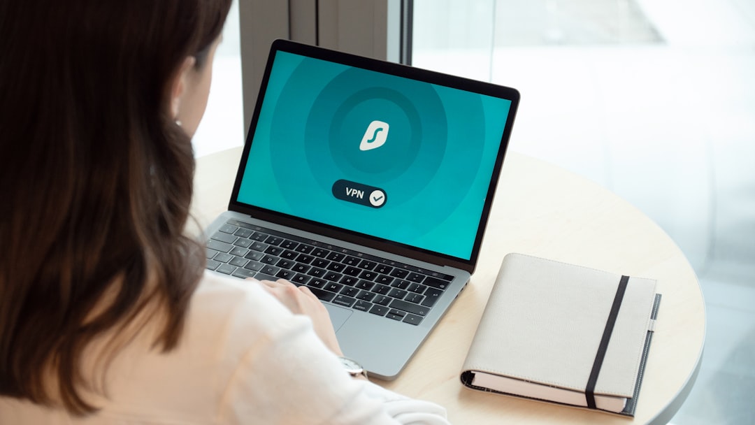 woman in white long sleeve shirt using macbook pro, Remote work with encrypted connection