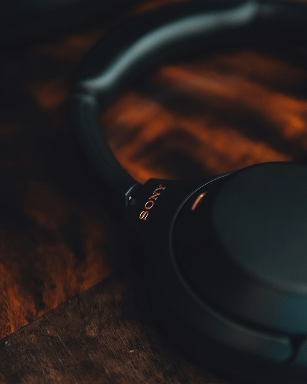 black sony headphones on brown wooden table
