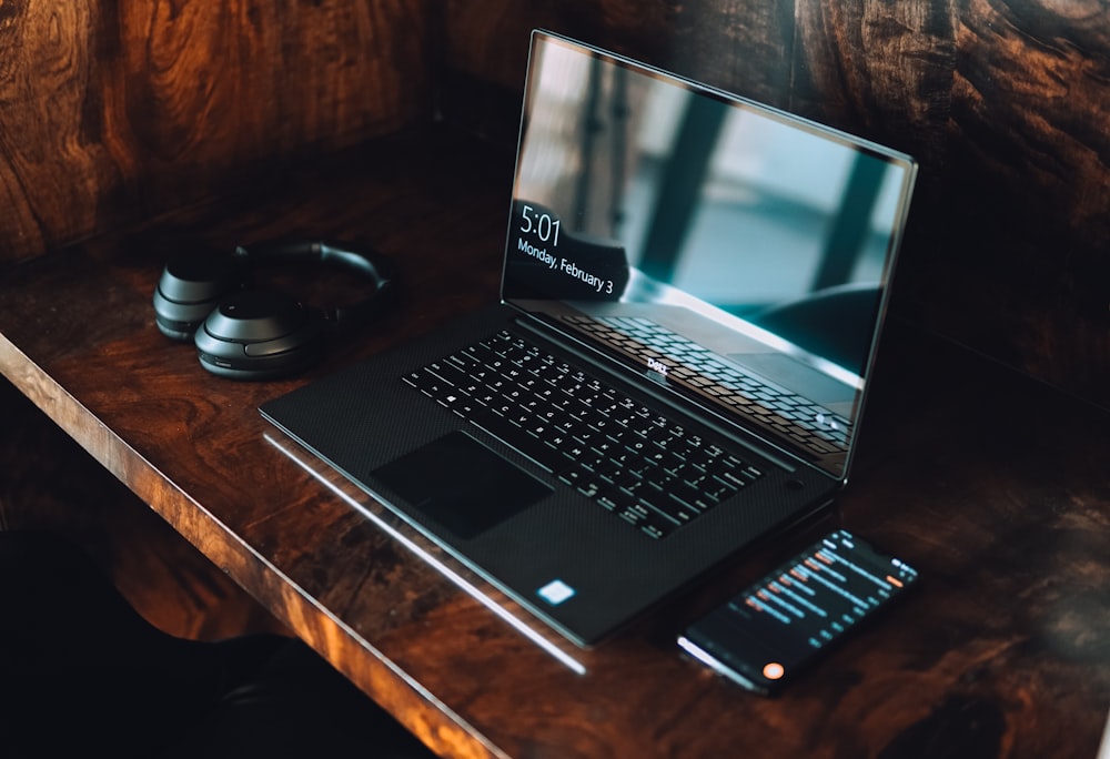 Computer portatile Asus nero su tavolo di legno marrone