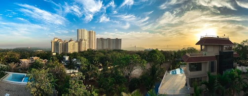 Panoramic render of the urbanization showing eco-friendly homes and green spaces at sunrise.