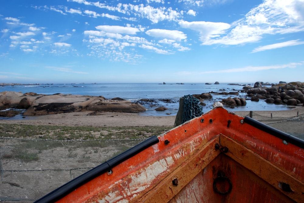 brown boat on seashore during daytime