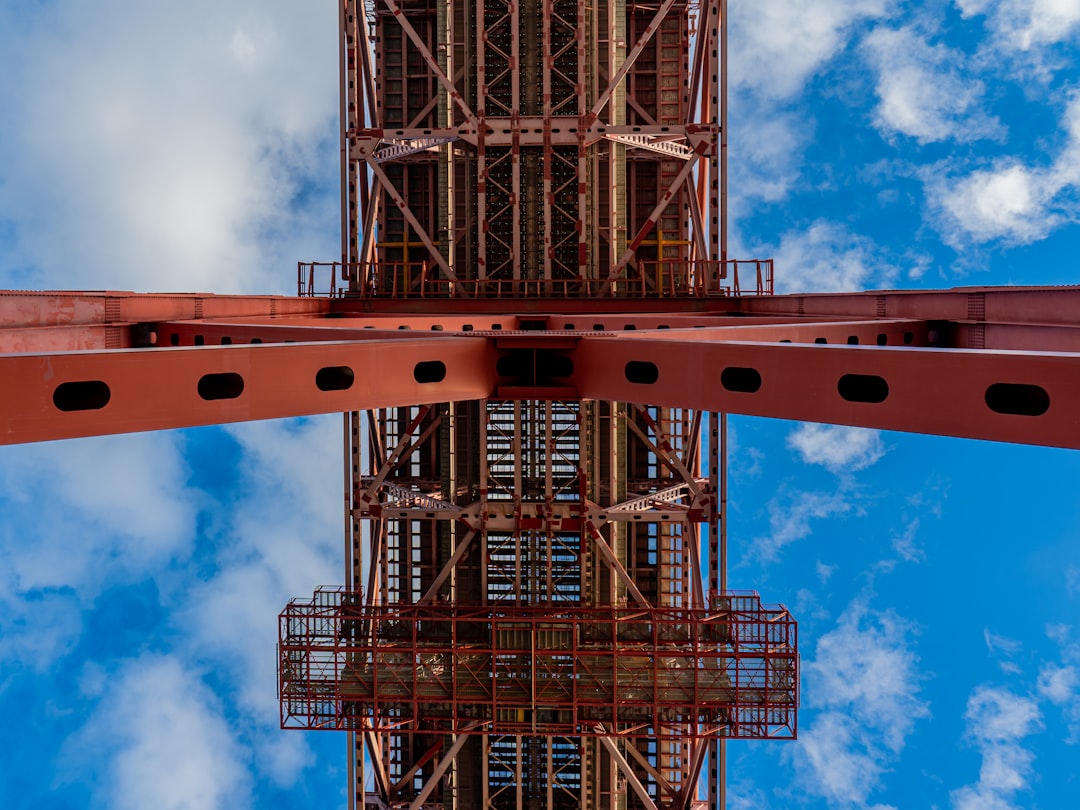 black metal tower under blue sky and white clouds during daytime