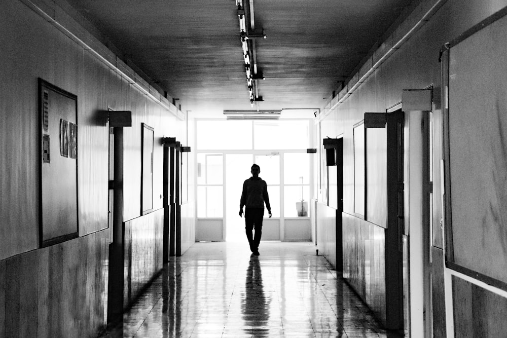 silhouette of person walking on hallway