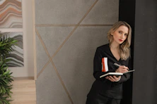 woman in black long sleeve shirt holding book