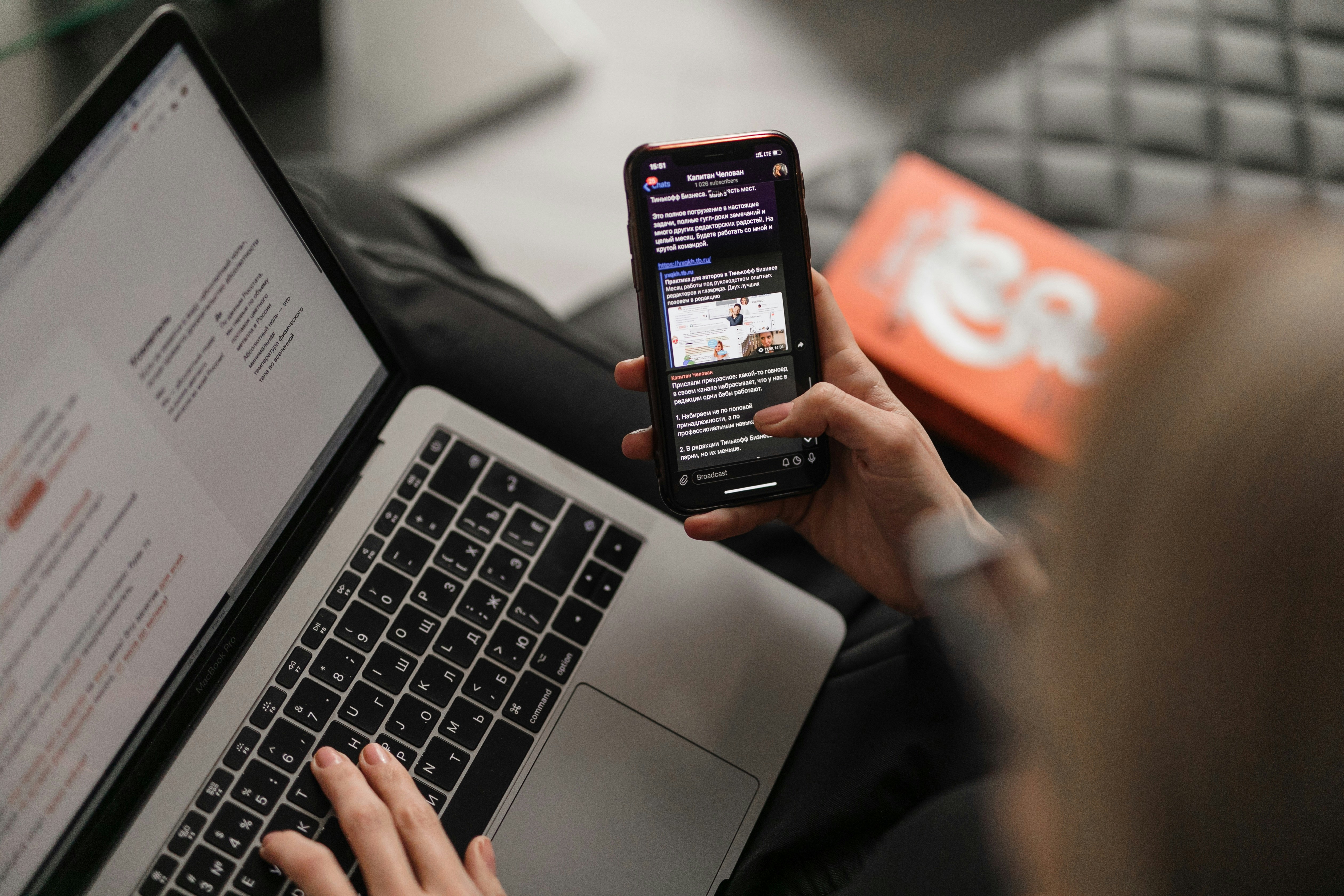 smartphone resting next to open laptop displaying digital assistant dashboard