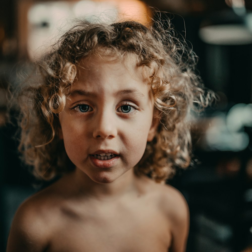 topless boy with brown curly hair