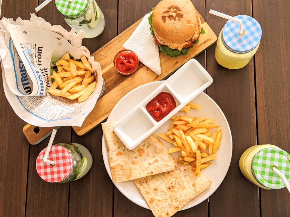 burger and fries on white ceramic plate