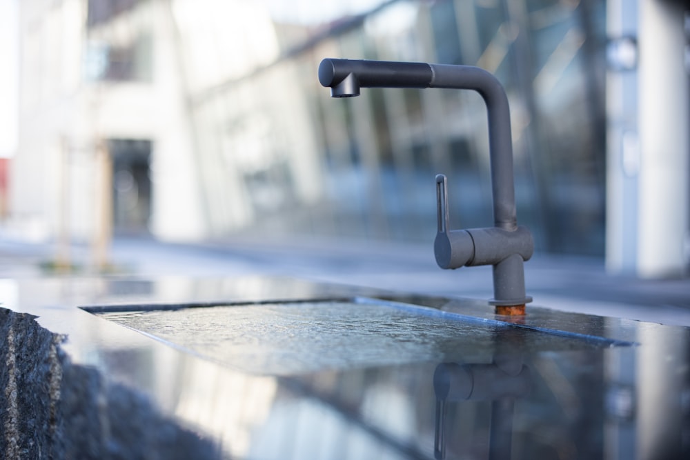 grey metal pipe on grey wooden table