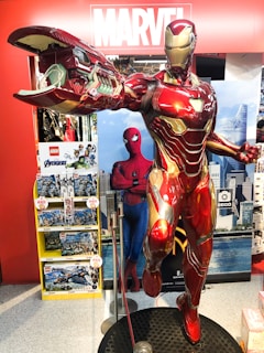 A vibrant display of Iron Man armor models and 3D printed geek merchandise in a modern store setting.