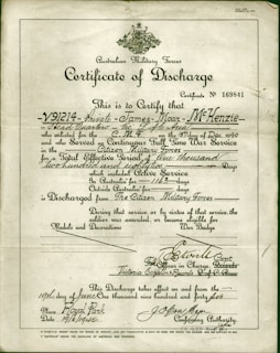 A formal document titled 'Certificate of Discharge' from the Australian Military Forces. It contains printed and handwritten text certifying the discharge of a private, along with dates, service details, and signatures. The background is a light, aged paper, with a green border and an emblem at the top center.