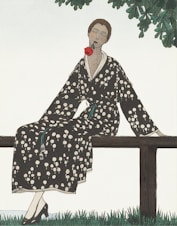 woman in black and white floral robe sitting on brown wooden bench