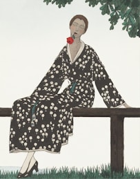 woman in black and white floral robe sitting on brown wooden bench