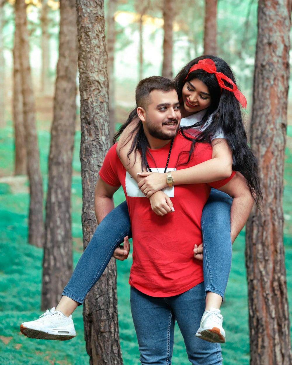 woman in red shirt hugging man in blue shirt