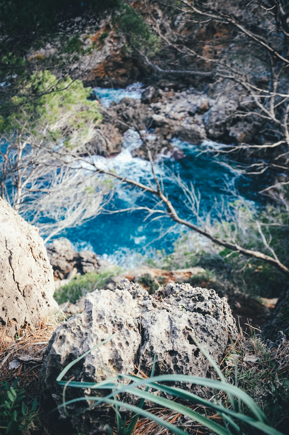 brown rocky mountain near blue body of water during daytime