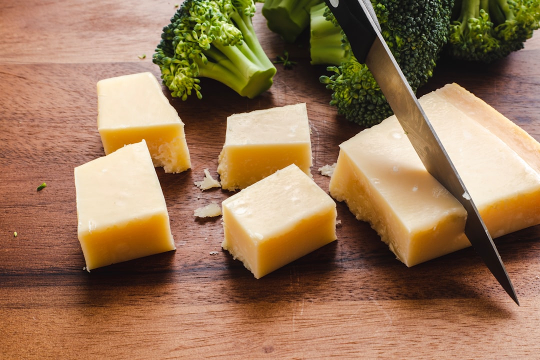 sliced cheese beside green broccoli