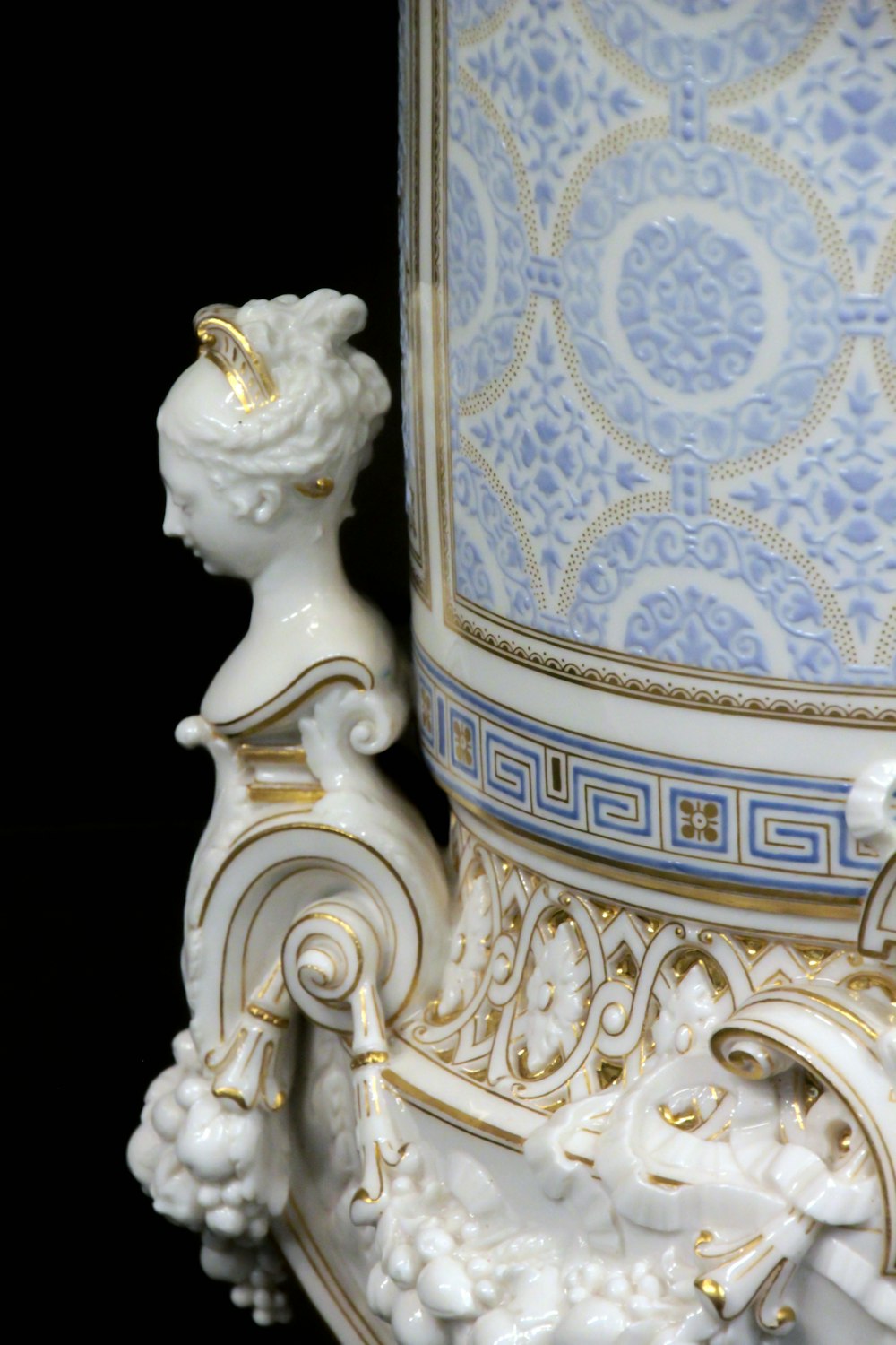 white and blue floral ceramic figurine