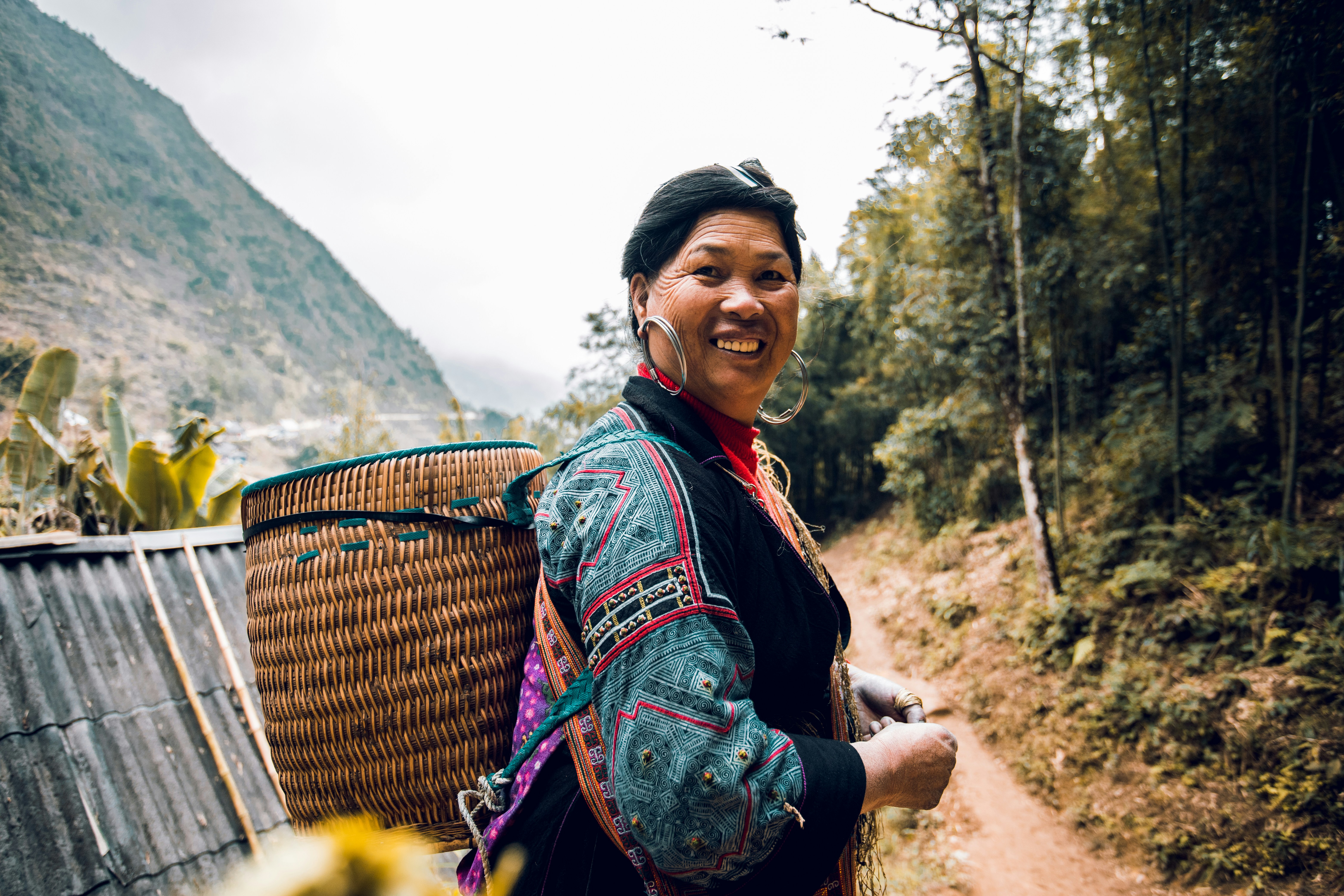 woman in black and red long sleeve shirt standing on brown dirt road during daytime