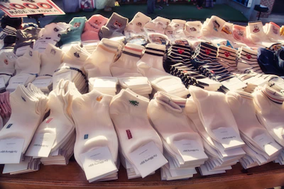 A vibrant display of colorful socks neatly arranged on production shelves inside the Aims Hosiery factory in Lahore.