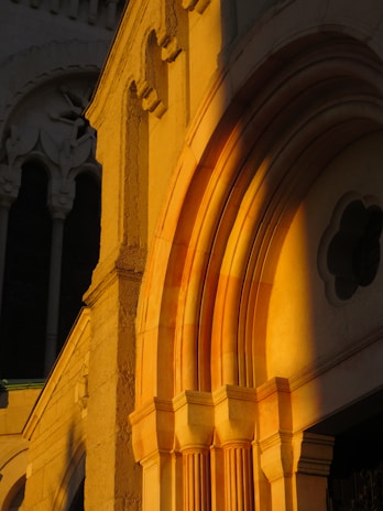 A serene architectural detail of a stone archway bathed in soft, natural light.