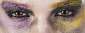 Close-up of a dramatic makeup look featuring bold eyeliner and shimmering accents reminiscent of Greek gods.