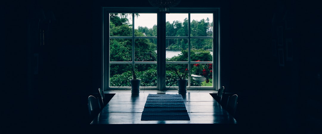 black wooden table near window