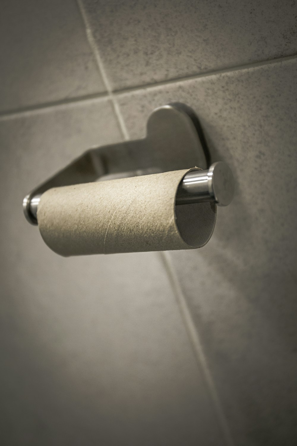 white toilet paper roll on stainless steel toilet paper holder