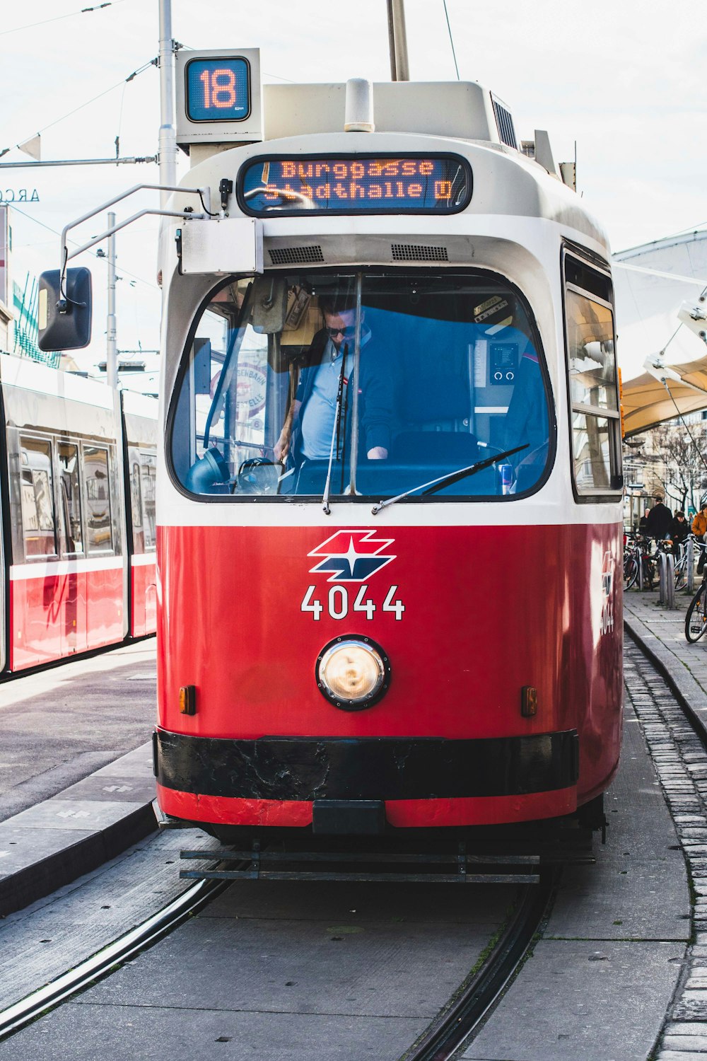 red and white tram on road during daytime