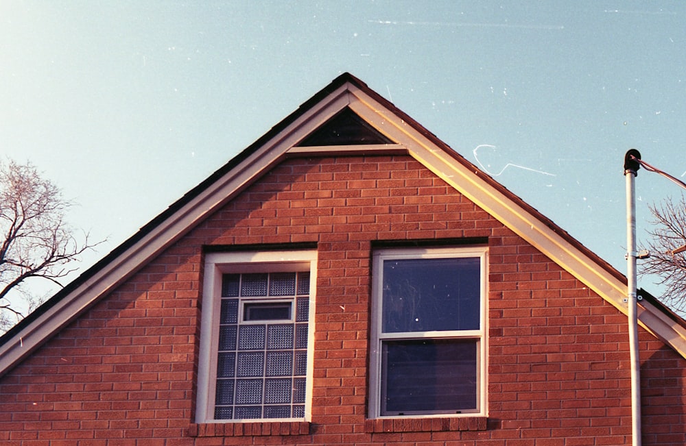 brown brick house under blue sky