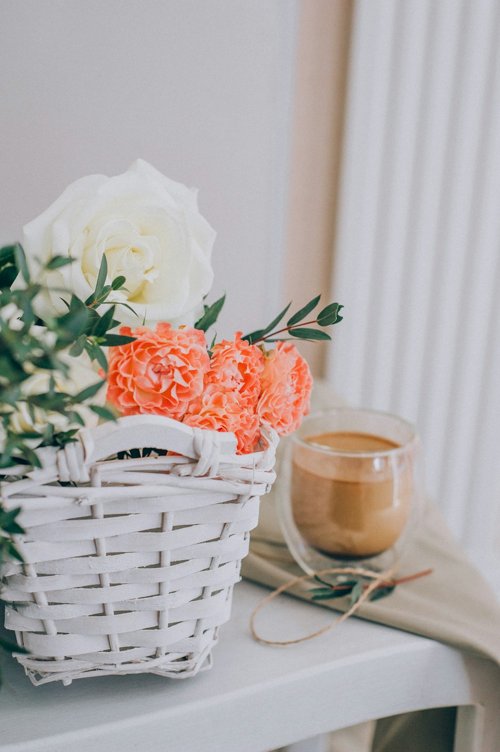 white rose in white wicker basket