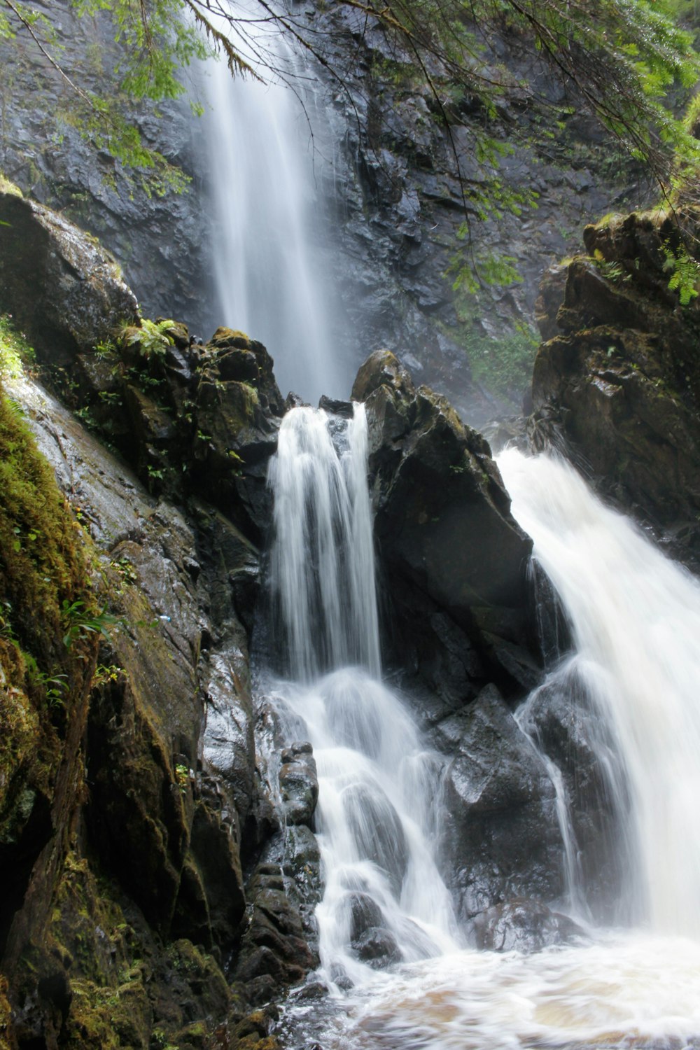 a waterfall with water cascading down the side of it